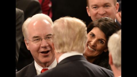 Trump shakes hands on his way through the chamber. Facing the President here are Health and Human Services Secretary Tom Price, left, and UN Ambassador Nikki Haley.