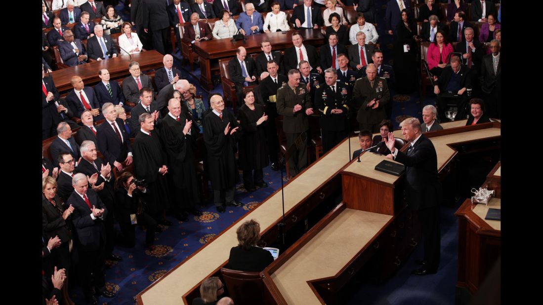 The President waves before starting his speech.