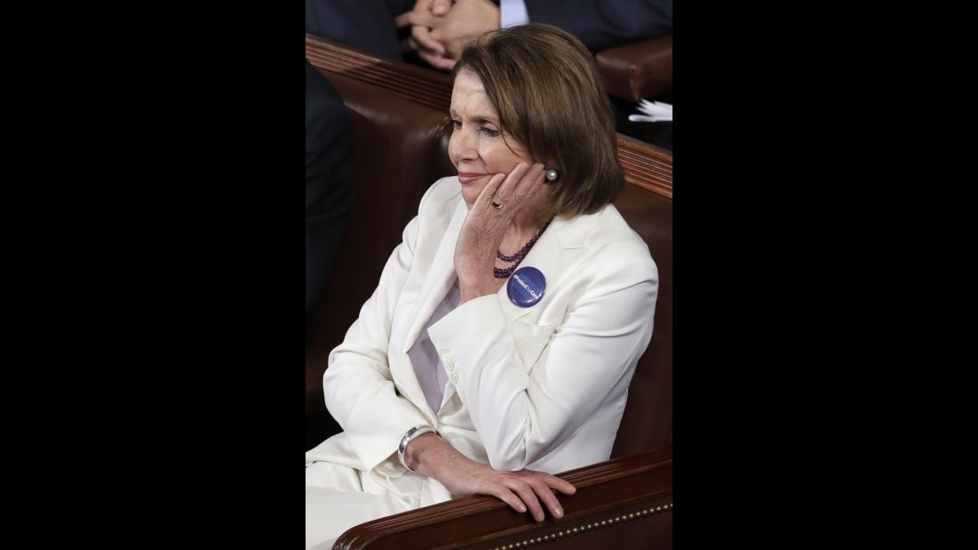 House Minority Leader Nancy Pelosi listens to the speech.