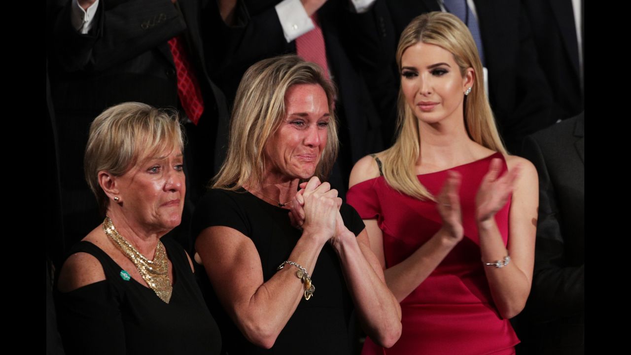Carryn Owens, center, cries as she is applauded by the chamber during Trump's speech. Owens' husband, Navy SEAL William "Ryan" Owens, recently was killed during a mission in Yemen. "Ryan died as he lived: a warrior and a hero, battling against terrorism and securing our nation," Trump said. The applause lasted over a minute, which Trump said must be a record.