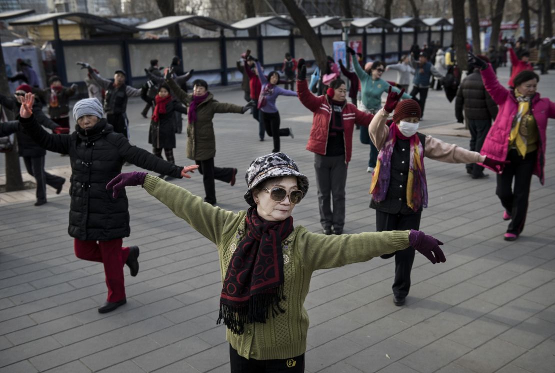 Chinese women dance as they exercise at a public park on December 21, 2014 in Beijing.