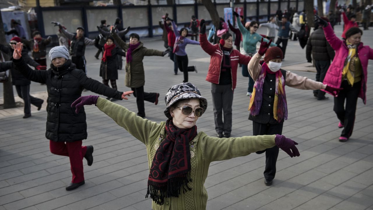  Chinese women dance as they exercise at a public park on December 21, 2014 in Beijing.