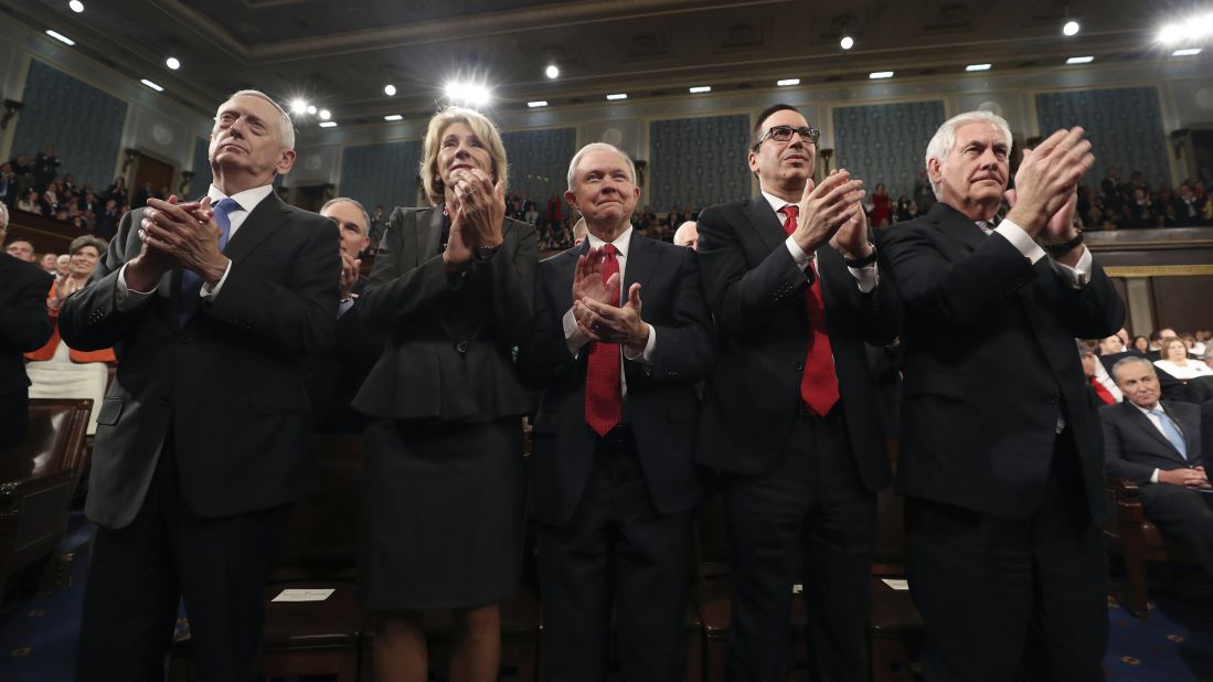 Members of Trump's Cabinet applaud the President. From left are Defense Secretary James Mattis, Education Secretary Betsy DeVos, Attorney General Jeff Sessions, Treasury Secretary Steve Mnuchin and Secretary of State Rex Tillerson.