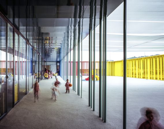 This kindergarten is built using colorful vertical tubes to create a rainbow effect. Some of the tubes can be rotated by children for fun. 