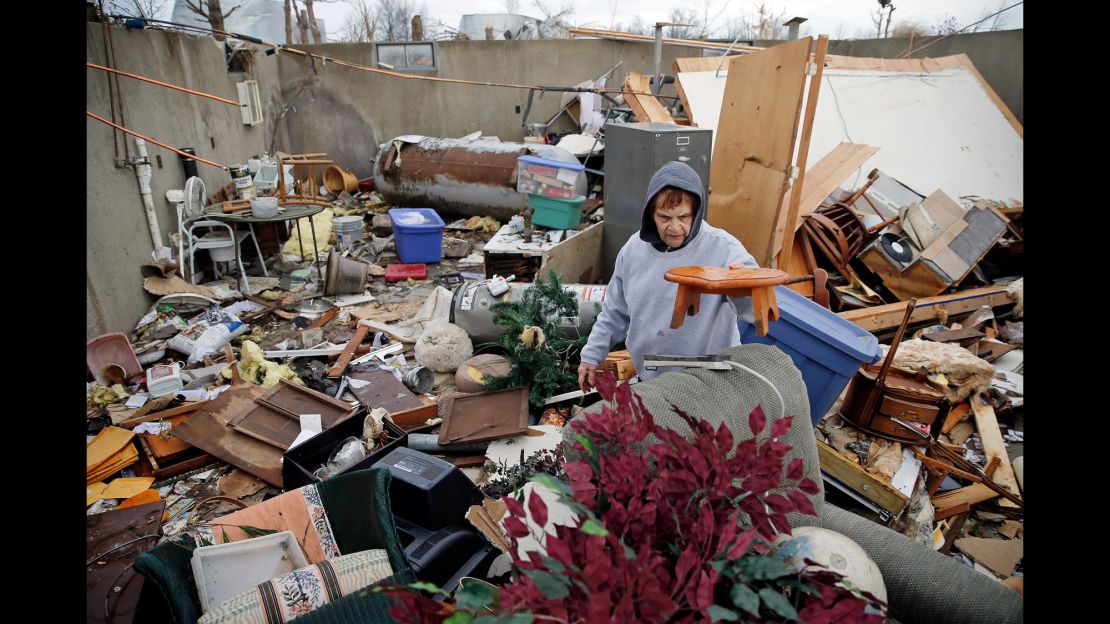 Pat Harber of Perryville, Missouri, looks through the wreckage of her  home.