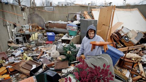 Pat Harber of Perryville, Missouri, looks through the wreckage of her  home.