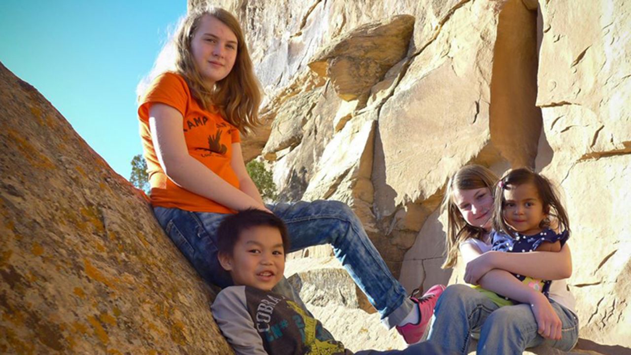 Maria hikes with her adopted sisters and brother. 