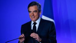 Conservative presidential candidate Francois Fillon adjusts microphones before a press conference at his campaign headquarters in Paris, Wednesday, March 1, 2017. Fillon's campaign for the French presidency faced new uncertainty Wednesday as he abruptly canceled a campaign stop at the country's premier farm fair and an investigation intensified into alleged fake parliamentary jobs for his family. (AP Photo/Francois Mori)