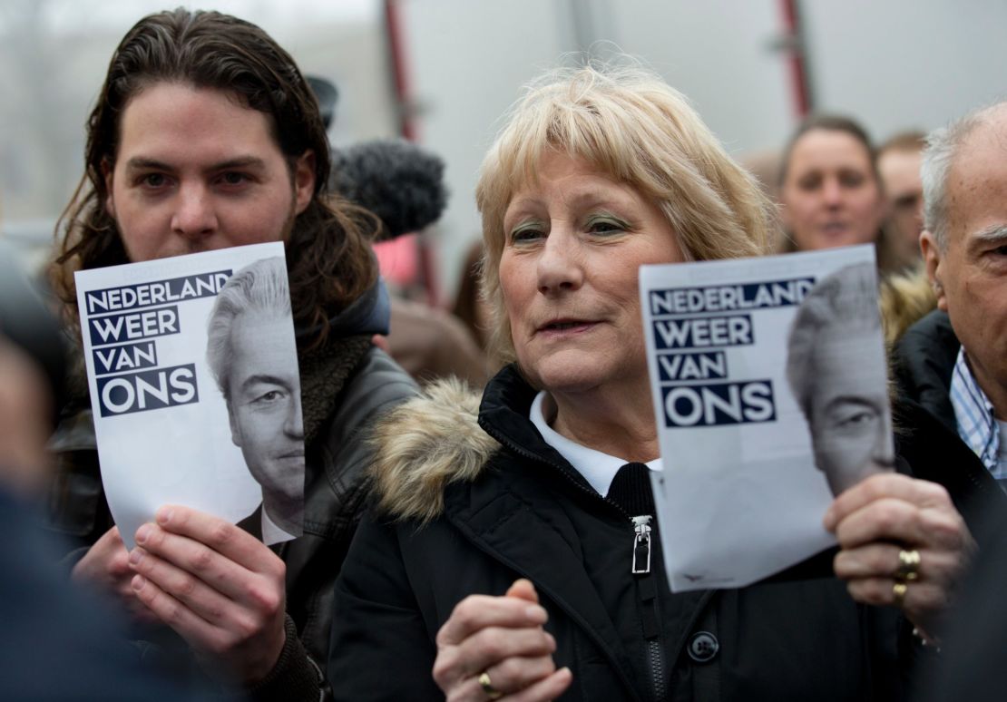 Geert Wilders supporters hold flyers with the message "The Netherlands ours again" during an election campaign stop in Spijkenisse, near Rotterdam, in February.