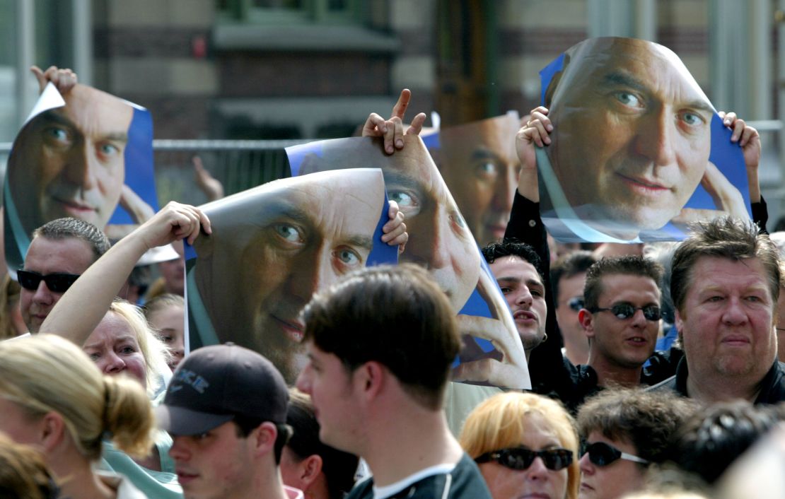 People hold up posters of Pim Fortuyn in Rotterdam, days after he was assasinated May 2002.