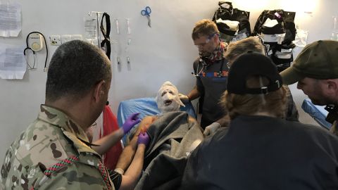 Volunteers treat a soldier injured in a suicide car bomb attack.