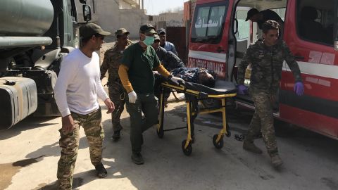 An injured soldier is rushed into the clinic from an ambulance.