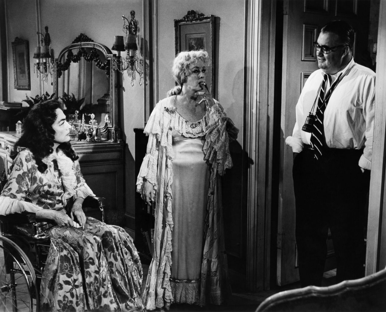 Crawford approached director Robert Aldrich, right, about teaming her with Davis in the "Sunset Boulevard"-type story of two show-biz sisters trapped in a decaying Hollywood mansion -- one crippled emotionally, the other in a wheelchair.  "Baby Jane" became a sleeper hit when released in the fall of 1962.  It revitalized the careers of Davis and Crawford and created a Hollywood genre in the '60s: schlocky horror films starring aging actresses.