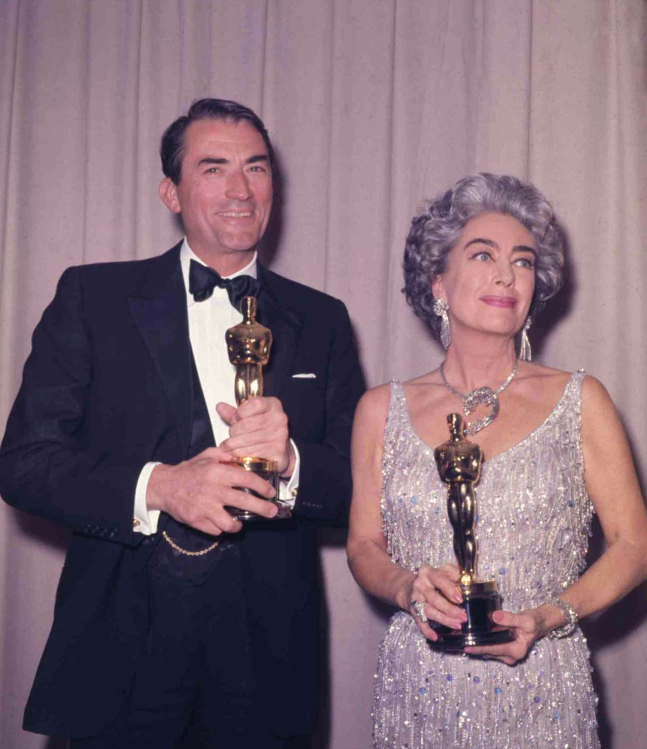 Crawford shares the Oscar spotlight with best actor winner Gregory Peck ("To Kill a Mockingbird") at the 1963 ceremony. She holds the best actress award for Anne Bancroft ("The Miracle Worker"), who was appearing in a play in New York. Davis received her 10th Oscar nomination for best actress for "Baby Jane" -- then a record -- and she hoped to become the first actress to win three Academy Awards. She was devastated when she lost, but Crawford wasn't. Denied a nomination herself, Crawford offered to accept the award for Bancroft or other no-show nominees, infuriating Davis. 