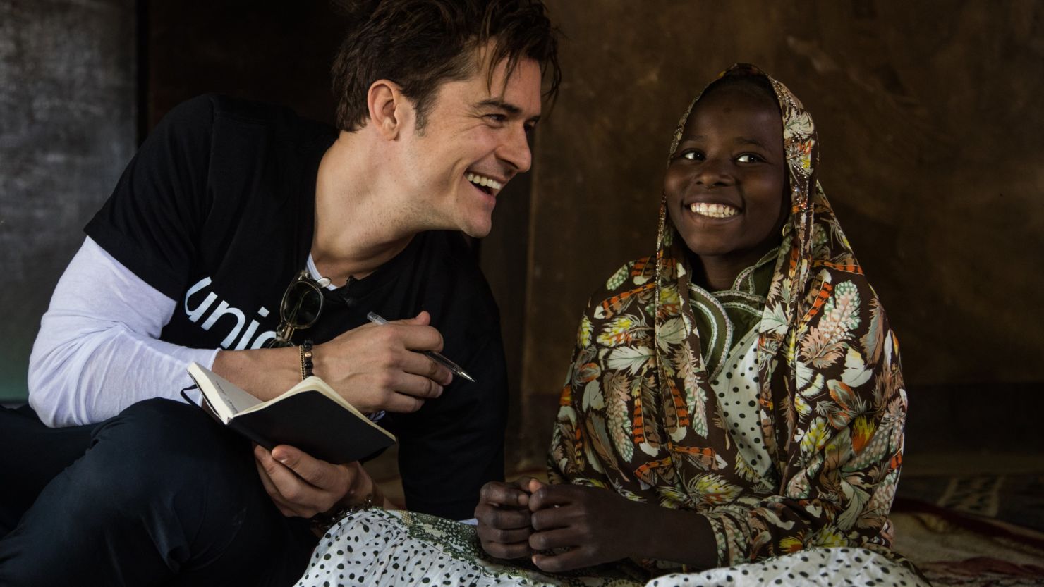UNICEF Goodwill Ambassador Orlando Bloom (left) smiles as he speaks with twelve-year-old Eta Ibrahim at her family's home, where she lives with her father - the village chief, and her four siblings, in Bosso, Niger, Sunday 19 February 2017. 