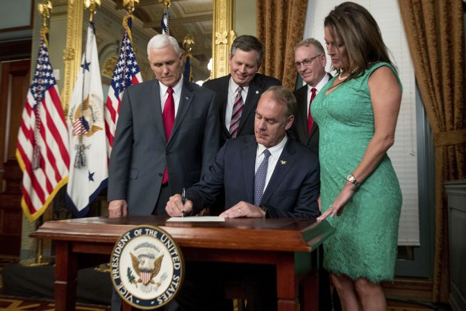New Interior Secretary Ryan Zinke signs an official document after he was <a href="index.php?page=&url=http%3A%2F%2Fwww.cnn.com%2F2017%2F03%2F01%2Fpolitics%2Fryan-zinke-confirmation-vote-interior-secretary%2F" target="_blank">confirmed by the Senate</a> on Wednesday, March 1. The former congressman from Montana was joined by his wife, Lolita, as well as Vice President Mike Pence, US Sen. Steve Daines and Montana Attorney General Tim Fox.