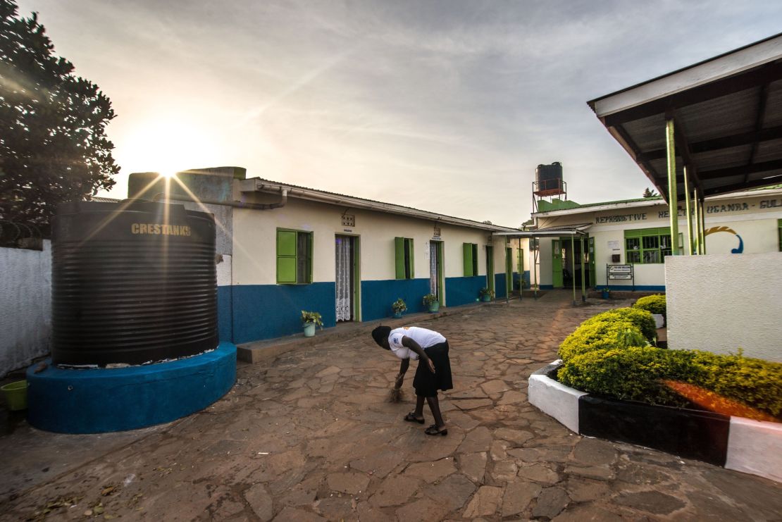 A RHU staff member sweeps the clinic's courtyard in the early morning before the first patients arrive.
