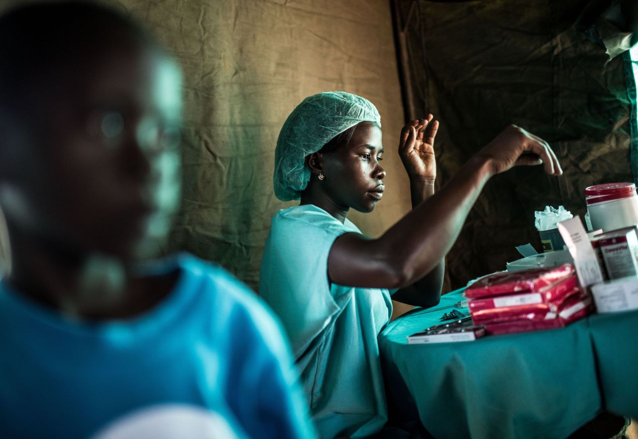 A nurse dispenses drugs during a  RHU mobile clinic expedition to the village of Ochaga, Uganda. 