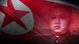 Kim Jong Un with flag t1