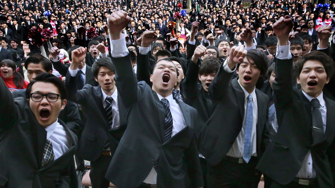 College students raise clenched fists during a joint pep rally to launch their job hunt Wednesday, March 1, at Tokyo's Hibiya Park.