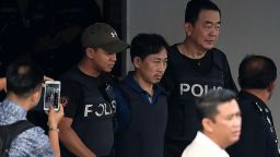 North Korean national Ri Jong Chol is escorted with a heavy police presence as he leaves the Sepang police headquaters in Sepang on March 3, 2017. The only North Korean arrested over the dramatic airport assassination of Kim Jong-Nam is to be deported, Malaysia said on March 2, as it announced the abrupt cancellation of a visa-waiver programme with Pyongyang.  