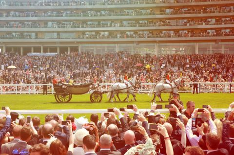 Queen Elizabeth's horse-drawn carriage makes its way down Ascot's straight mile.