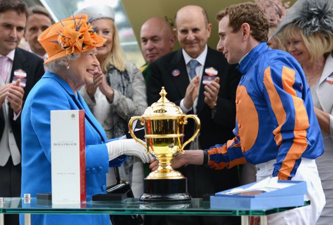 Ryan Moore receives the Gold Cup trophy after riding to victory on Order of St George at Royal Ascot's showpiece event. The trophy is traditionally competed for on the third day (Thursday) of the races, known as "Ladies Day."
