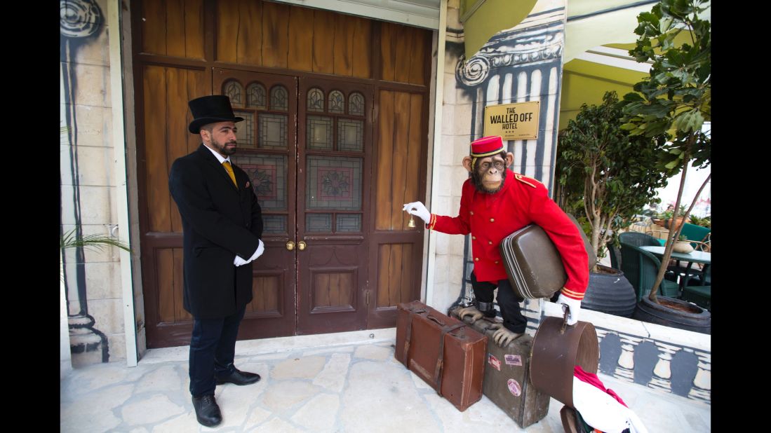 The establishment is operated by the local community. Here, a doorman stands at the entrance of the hotel. 
