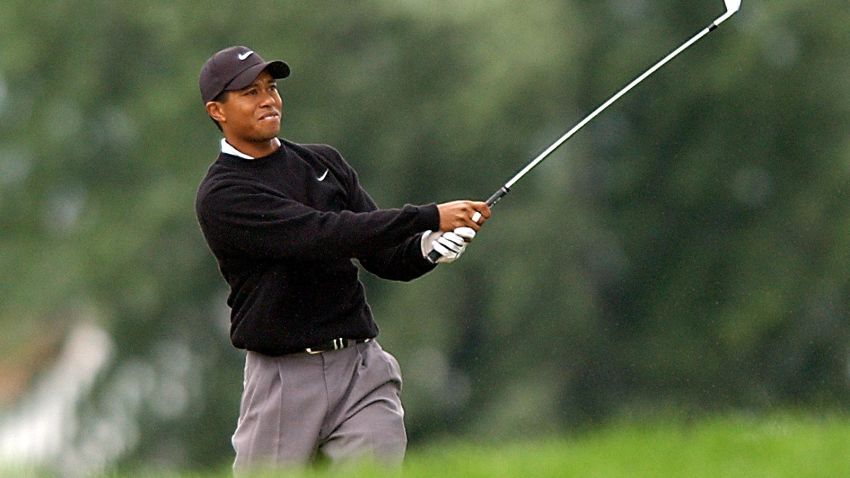 CHASKA, UNITED STATES:  Tiger Woods of the US watches his bunker shot on the 18th hole drop into the cup to finish his suspended second round of 2002 PGA championship 17 August 2002 at Hazeltine National Golf Club in Chaska, Minnesota. Woods finished the round with a 69 for a two-day total of four under par.    AFP PHOTO Roberto SCHMIDT (Photo credit should read ROBERTO SCHMIDT/AFP/Getty Images)