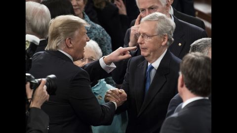 Trump greets Senate Majority Leader Mitch McConnell after delivering his speech to Congress.