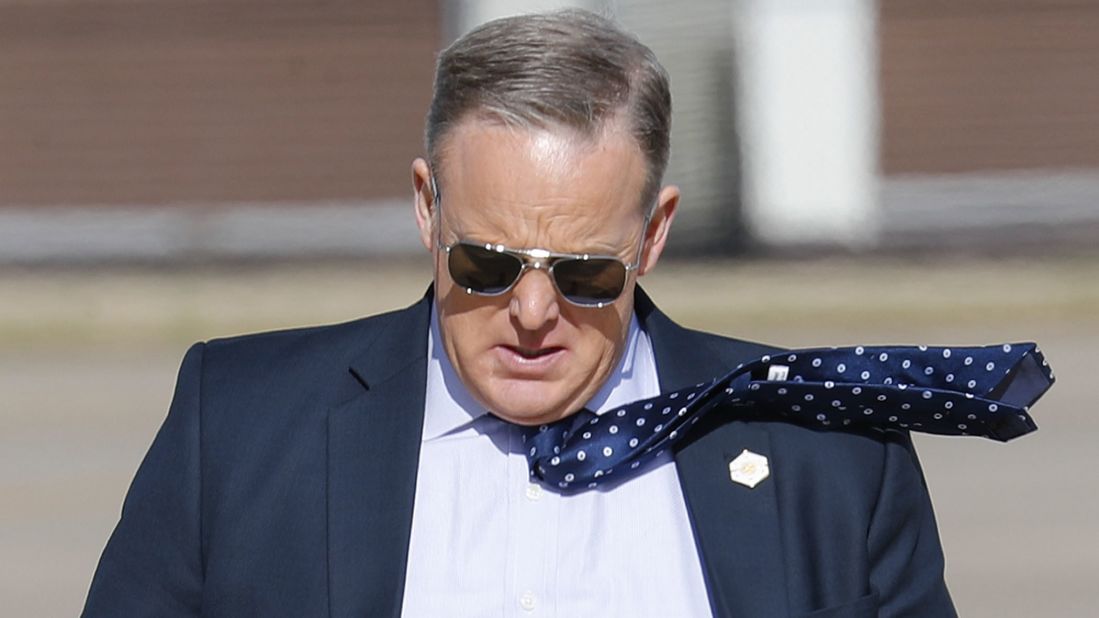 White House Press Secretary Sean Spicer walks across the tarmac Thursday, March 2, at Langley Air Force Base in Virginia.