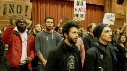 Middlebury College students turn their backs to Charles Murray, unseen, who they call a white nationalist, during his lecture in Middlebury, Vt., Thursday, March 2, 2017. Hundreds of college students on Thursday protested a lecture by a speaker they call a white nationalist, forcing the college to move his talk to an undisclosed campus location from which it was live-streamed to the original venue but couldn't be heard above protesters' chants, feet stamping and occasional smoke alarms. (AP Photo/Lisa Rathke)