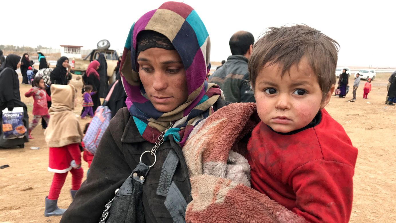 A woman from western Mosul carries her child and the few possessions she could gather before escaping the city. By Saturday, the Iraqi government estimated that nearly 50,000 people had fled western Mosul to government-controlled territory. Most ended up in refugee camps hastily set up by the government and local and international relief groups.