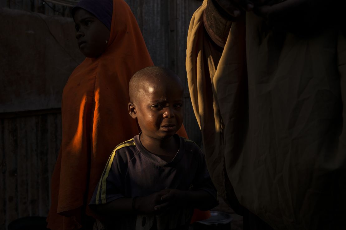 A young Somali boy grieves for his mother, who had died in a camp for displaced people