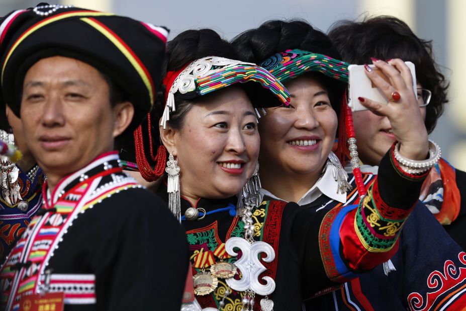 Minority delegates take a selfie as they arrive outside the Great Hall of the People.