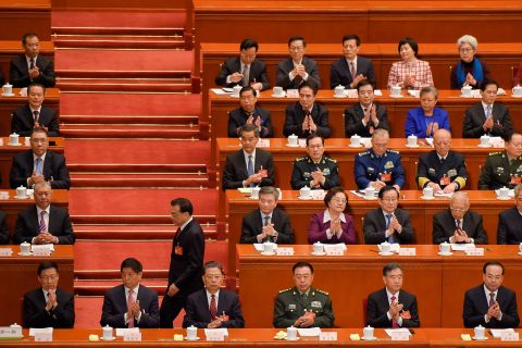 Premier Li Keqiang passes by delegates before his report during the opening session.