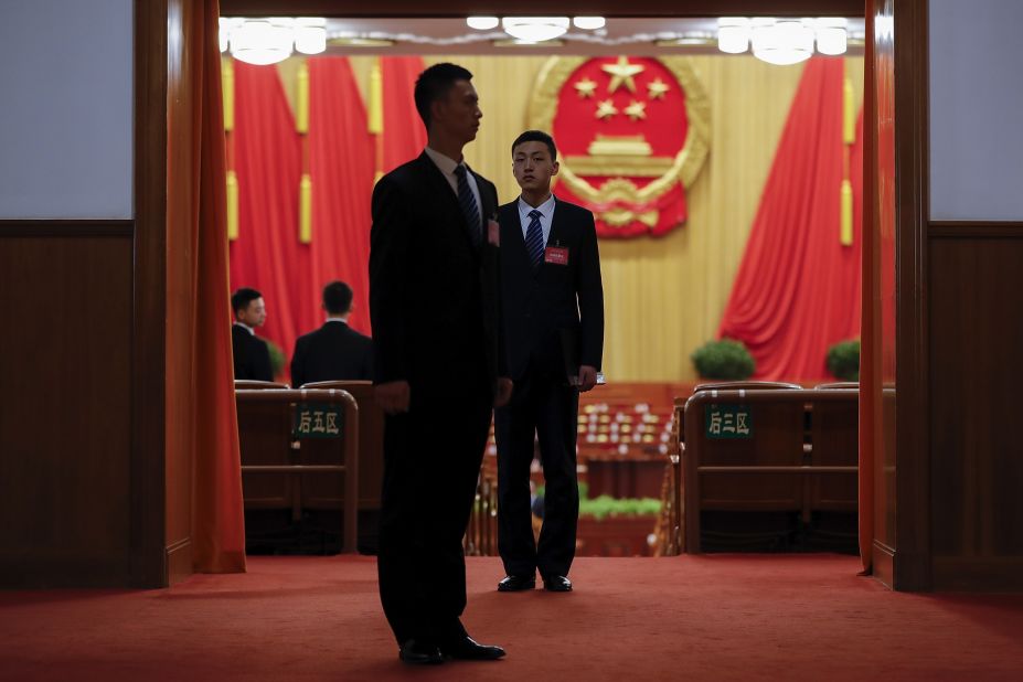 Chinese armed police stand guard inside the Great Hall of the People before the opening session.