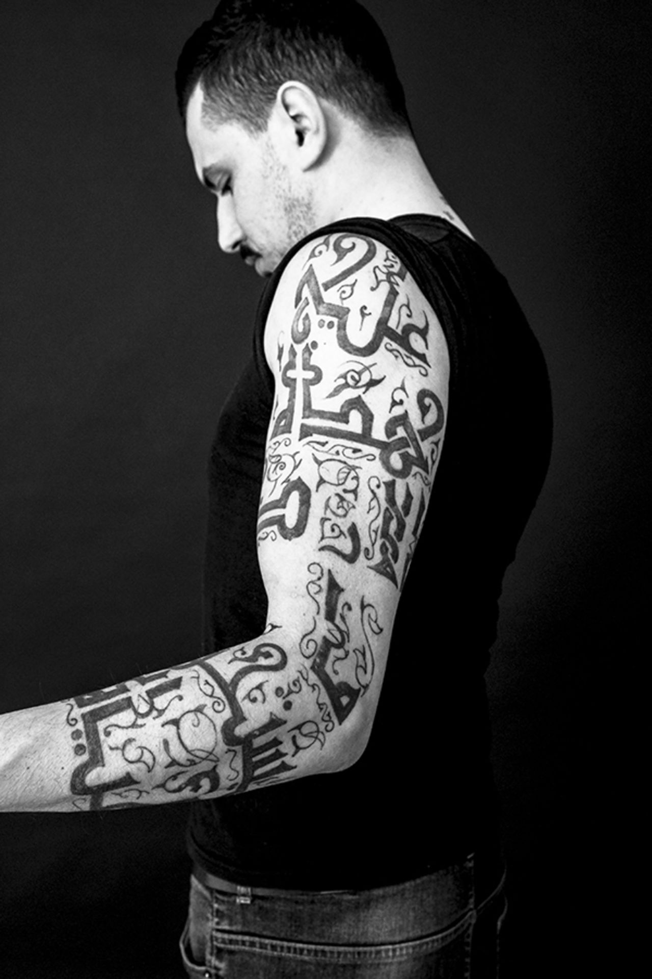 Akram Al Deek's tattoo is a line of poetry by Mahmoud Darwish "On this earth what's worth living for."