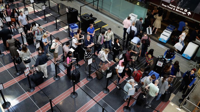 Passengers queue up outside a Transportation Security Administration checkpoint at Ronald Reagan National Airport May 27, 2016 in Arlington, Virginia.