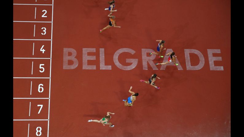 Sprinters cross the finish line of a 60-meter race at the European Indoor Championships on Friday, March 3.