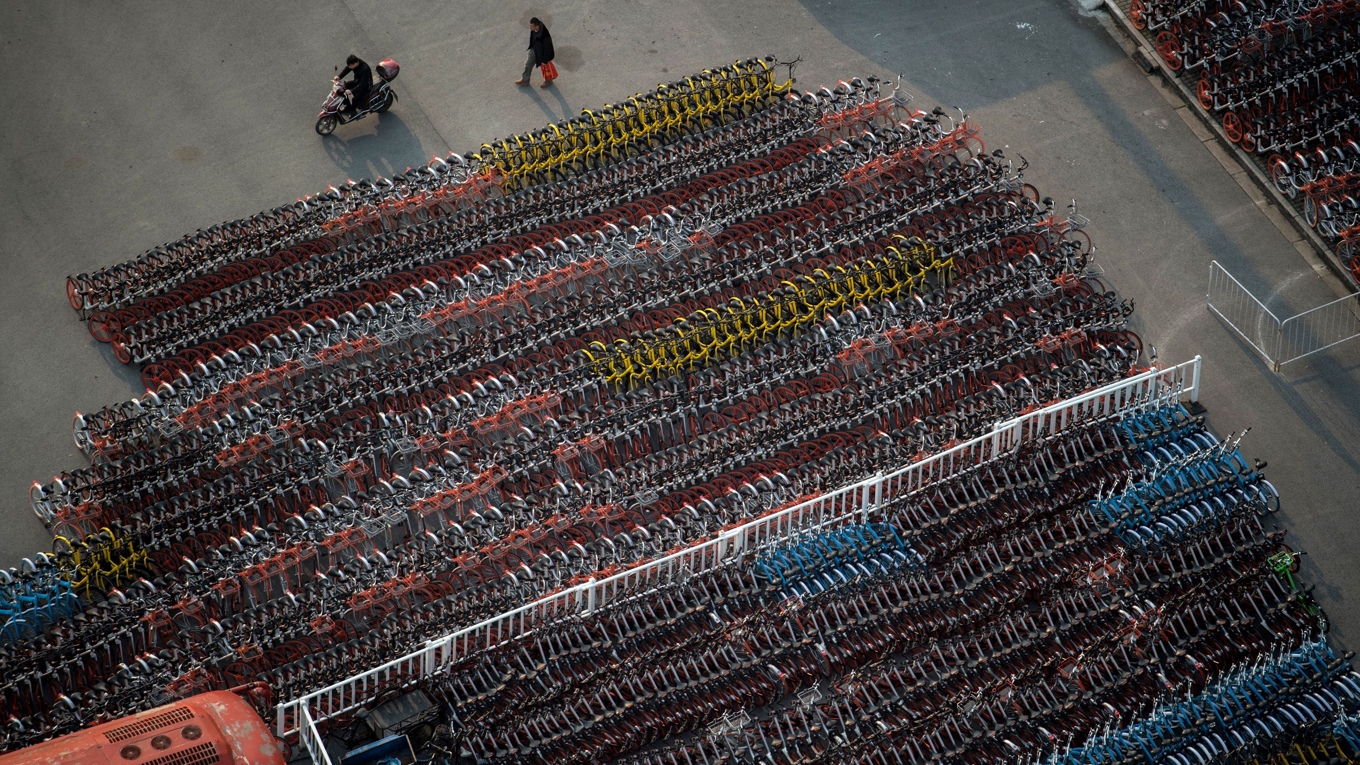 A man walks past impounded bicycles from th