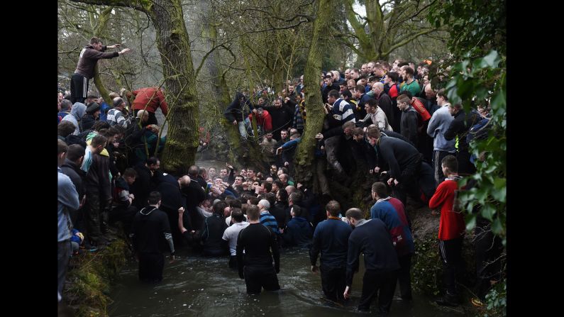 People tussle in a river Tuesday, February 28, as they take part in the Royal Shrovetide Football match, <a href="index.php?page=&url=http%3A%2F%2Fwww.cnn.com%2F2013%2F02%2F13%2Feurope%2Fgallery%2Fashbourne-football%2Findex.html" target="_blank">a brutal, rugby-style game</a> that occurs annually in Ashbourne, England. Hundreds of participants try to get a ball into one of two goals positioned 3 miles apart at either end of Ashbourne.