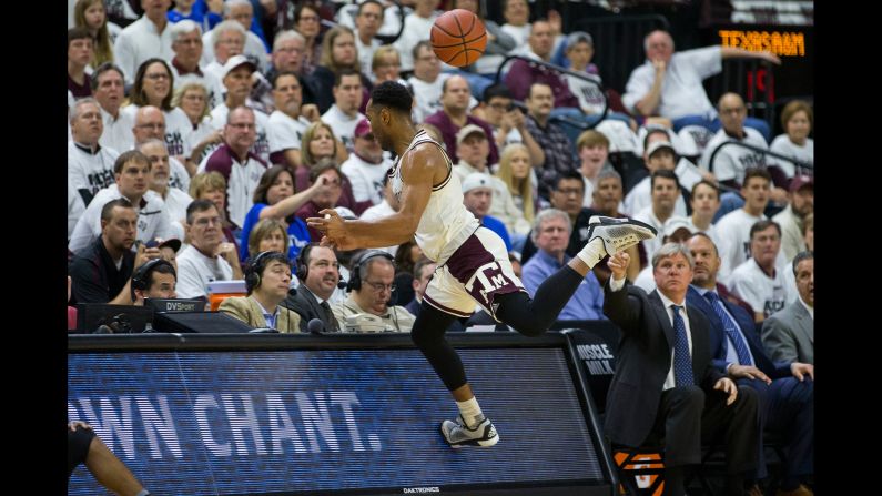 Texas A&M guard J.C. Hampton runs into the scorers' table during a home game against Kentucky on Saturday, March 4.