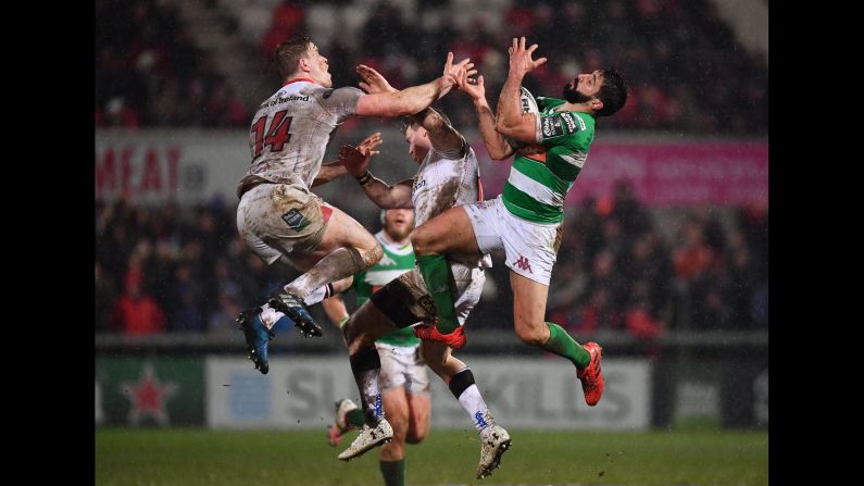 Ulster's Andrew Trimble, left, jumps near Benetton Treviso's Tito Tebaldi during a Pro12 rugby match in Belfast, Northern Ireland, on Friday, March 3.