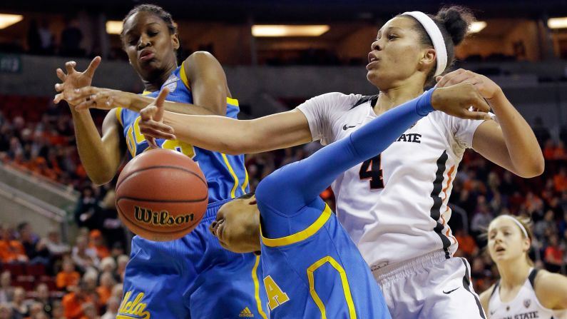 Oregon State's Breanna Brown, right, vies for a loose ball with UCLA's Kennedy Burke, left, and Kelli Hayes during a Pac-12 Tournament game on Saturday, March 4.