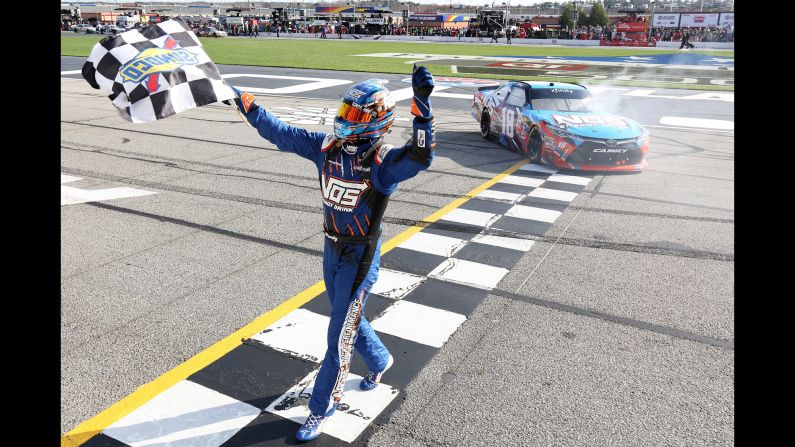 NASCAR driver Kyle Busch celebrates with the checkered flag Saturday, March 4, after winning the Xfinity Series race at Atlanta Motor Speedway.