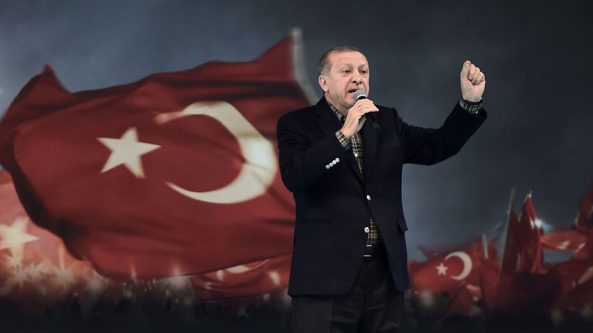 Turkish President Recep Tayyip Erdogan gestures as he delivers a speech on stage, on March 5, 2017 in Istanbul during a pro-government women meeting.
Some 12,000 women filled on March 5 an Istanbul arena in support of a "Yes" vote in an April referendum whether to boost Turkish President Recep Tayyip Erdogan's powers. Erdogan lashed out at Germany for blocking several rallies there ahead of an April vote in Turkey on boosting his powers as head of state, likening them to Nazi practices. "Your practices are not different from the Nazi practices of the past," Erdogan told a women's rally in Istanbul as Turks vote on April 16 whether to approve changes to the constitution expanding presidential powers.
 / AFP PHOTO / OZAN KOSE        (Photo credit should read OZAN KOSE/AFP/Getty Images)
