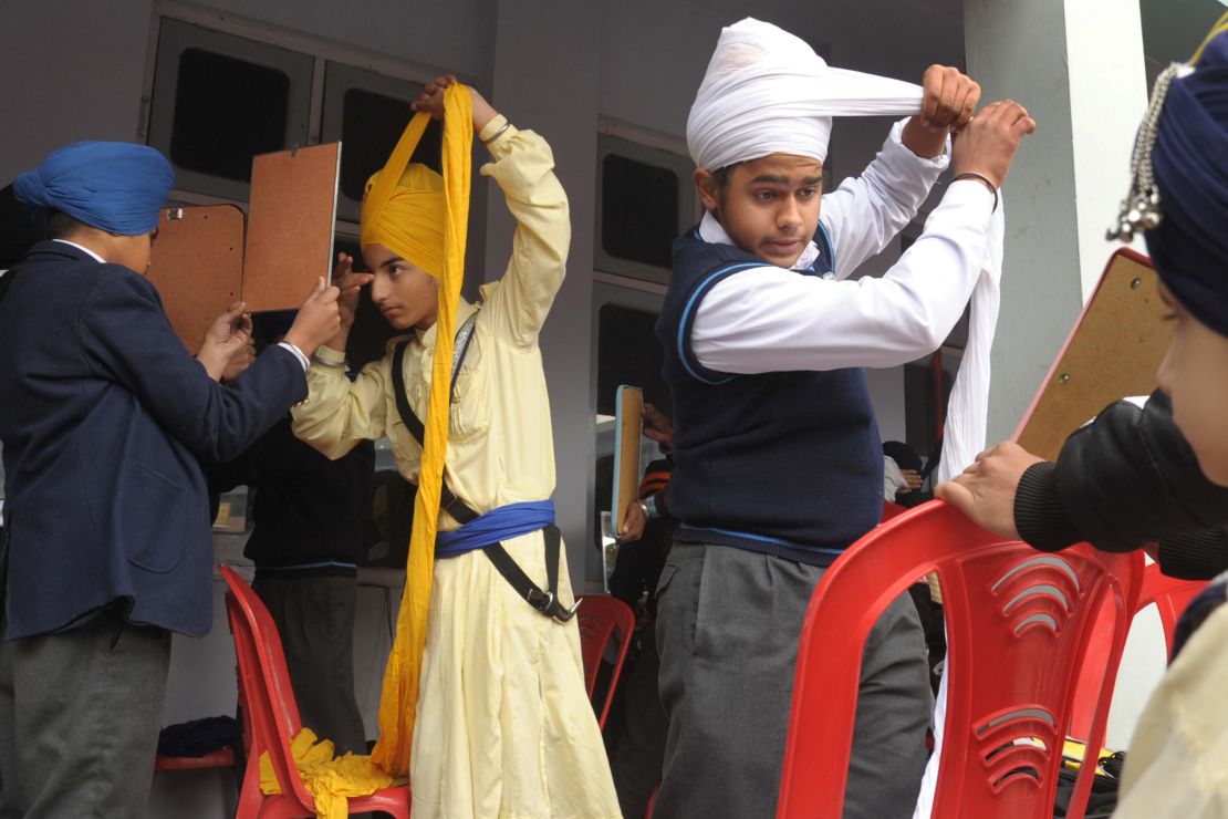 Young Indian Sikhs participate in a turban tying competition in 2014.