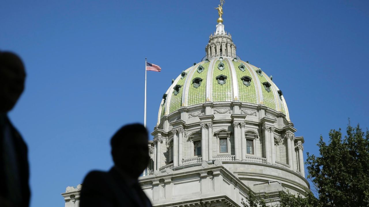In this Oct. 7, 2015 photo, people walk past the Pennsylvania Capitol building in Harrisburg, Pa. 