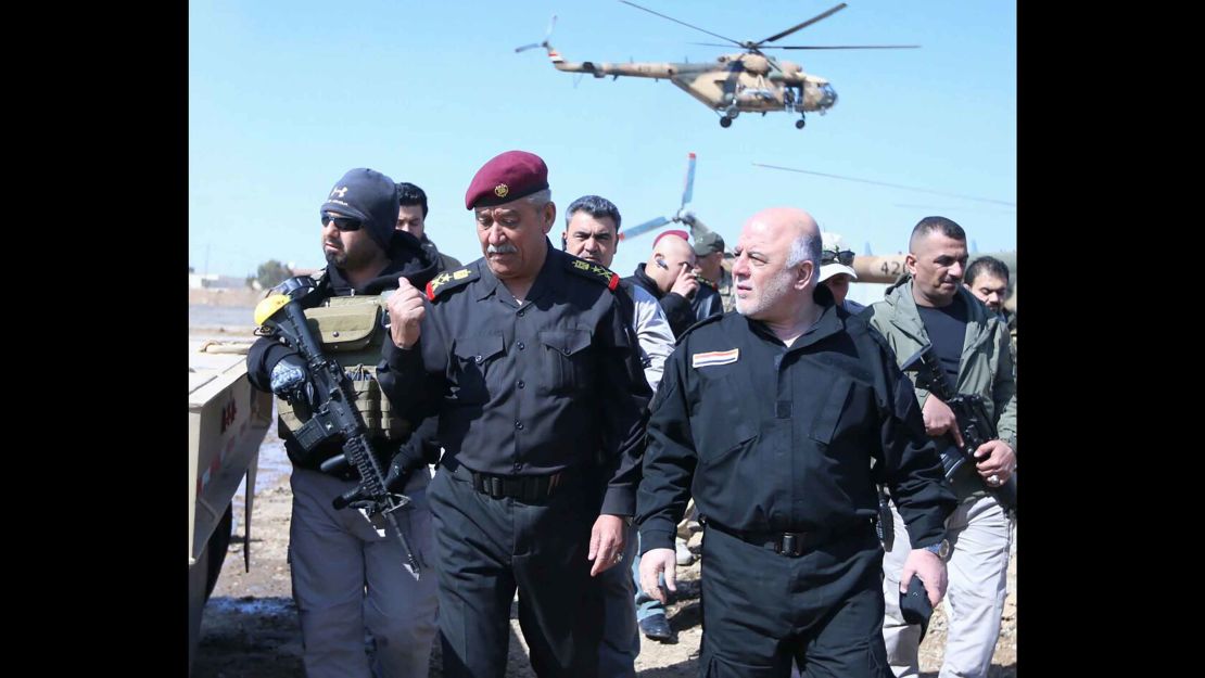 Iraqi Prime Minister Haidar al-Abadi, right, meets Iraqi forces in Mosul Tuesday.  